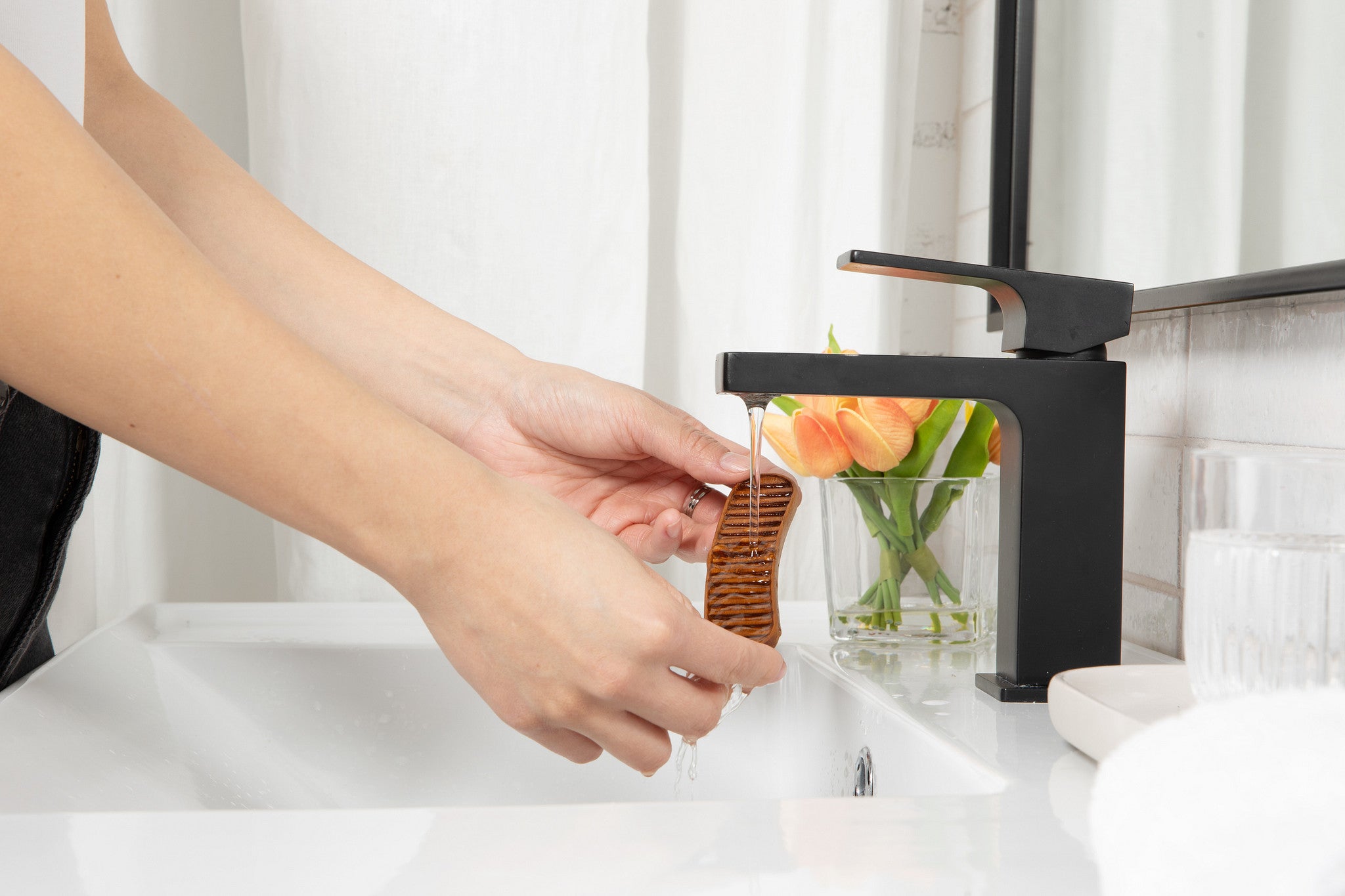 essential oil wood diffuser being rinsed in water